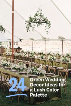 an outdoor tent set up for a wedding reception with greenery and flowers on the tables