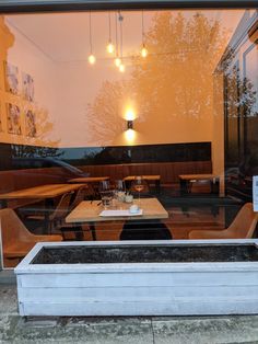 an empty table in front of a glass window