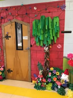 a classroom door decorated with paper flowers and plants