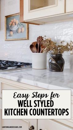 a white kitchen counter top with flowers in a vase on it and the words easy steps for well styled kitchen counters