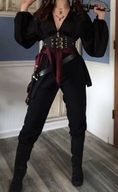 a woman dressed in pirate costume posing for the camera