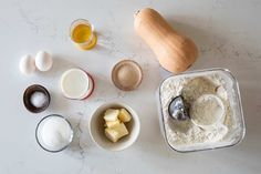 an assortment of ingredients on a table including butter, eggs, flour and other items