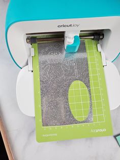 a cricutjoy machine with a cutting mat on it