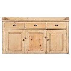 a wooden sideboard with four doors and two drawers