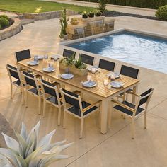 an outdoor dining table and chairs next to a swimming pool