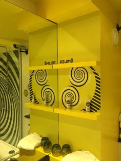 there is a bathroom with yellow walls and shelves