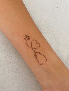 a small tattoo on the arm of a woman's left arm with a heart and flower