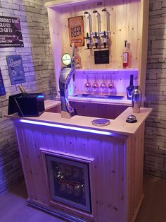 a small bar made out of pallet wood with purple lights on the front and back