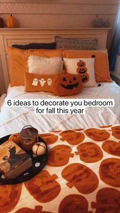 a bed room with a neatly made bed and halloween decorations on the headboard next to it