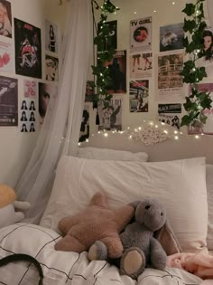 two teddy bears sitting on top of a bed in a room with posters and lights