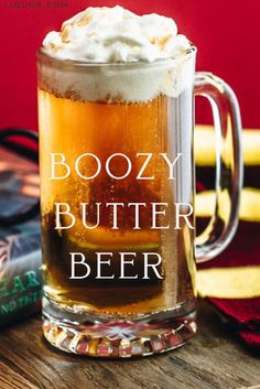 boozy butter beer in a glass mug with whipped cream on top and the title boozy butter beer