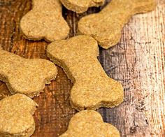 dog biscuits are spilled into a jar on a wooden table