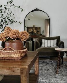 a living room filled with furniture and a vase on top of a wooden coffee table