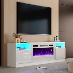 an entertainment center with a flat screen tv mounted on it's side and a fireplace in the middle