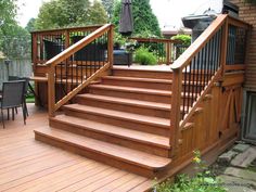 a deck with wooden steps and railings