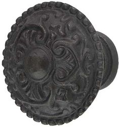 an old black door knob with ornate designs