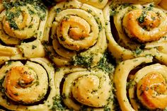 rolls covered in pesto and cheese on top of a pan