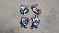 four pixel art pieces are laying on the ground next to each other and one is pink