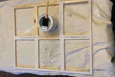 an unfinished window frame is being installed on the side of a wall with some paint