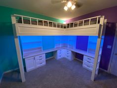 a loft bed with built in desk and drawers under the stairs is lit by blue lights