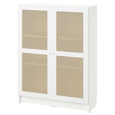 a white cabinet with two doors and some brown dots on the front, against a white background