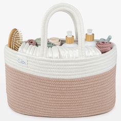 a white and beige basket filled with lots of items on top of a white surface