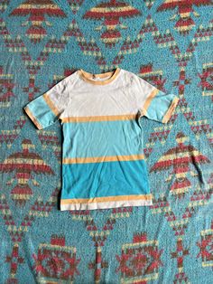 "This top has a simple and cheerful look to it. Great for everyday wear.  Fair shape. No tag. Bleach spot on one sleeve and two small spots along the bottom. Ca 1970s.  PTP: 14.5\" Length: 24\" If you have any questions, please send us a message. NGA *free shipping to lower 48 only" White Retro Print Top For Summer, Striped Color Block Cotton Tops, Retro Color Block T-shirt For Summer, 70s Inspired Cotton Tops With Retro Print, Cotton Tops With Retro 70s Print, Retro Cotton Summer Tops, Fitted Retro Print Crew Neck Tops, Fitted Cotton Color Block Shirt, Retro Cotton Tops For Summer