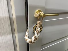 a door handle with a rope hanging from it's side and a lock on the outside