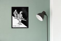 a black and white drawing of an astronaut on the moon next to a green wall