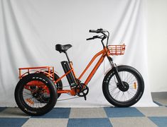 an orange bicycle is parked in front of a white wall and blue checkered floor