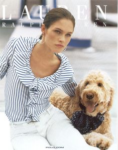 a woman sitting on the ground with her dog