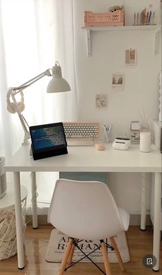 a white desk with a laptop on top of it next to a chair and lamp