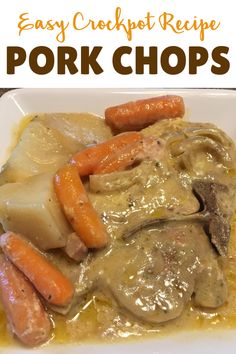 a white plate topped with pork chops covered in gravy and carrots