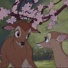 two deer standing next to each other in front of pink flowers on their antlers