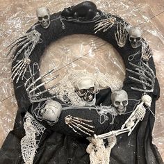 a wreath made out of fake skeletons and yarn