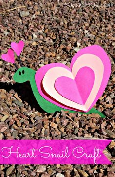 a paper heart snail craft on the ground