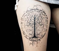 a woman's thigh with a tree tattoo on the leg and words written all over it