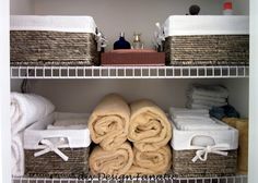 towels are stacked on shelves in a bathroom