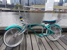 a blue bike parked on top of a wooden pier