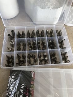 a plastic container filled with lots of screws next to a bag of white stuff