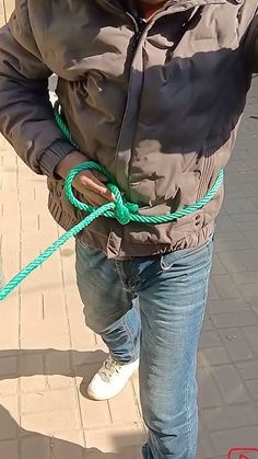 a man is holding onto a green rope