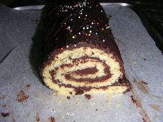 there is a chocolate roll with sprinkles on it