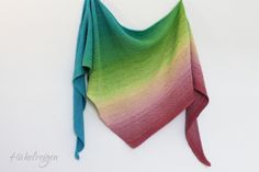 a multicolored shawl hanging on the wall