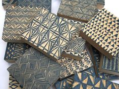 several pieces of art made out of wood with geometric designs on the top and bottom