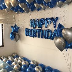 balloons and streamers in the shape of stars are on display at a birthday party