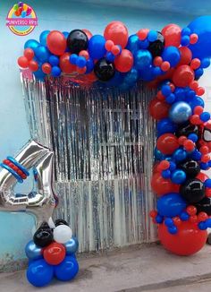 balloons and streamers decorate the entrance to a birthday party