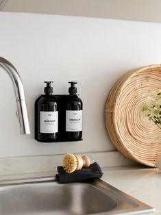 two bottles of shampoo sitting on top of a sink