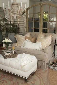 a living room filled with furniture and lots of pillows