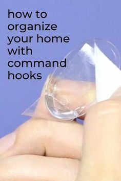 someone is holding a piece of paper in their hand with the words how to organize your home with command hooks