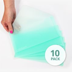 a hand is holding some clear plastic sheets with the words 10 pack in front of it